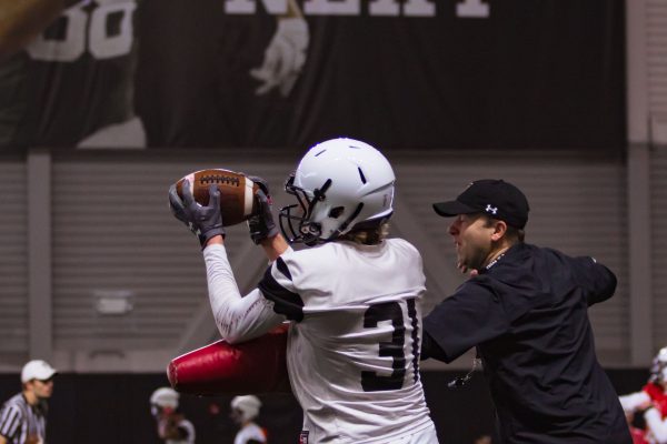 Redshirt Freshman Wide Receiver Dax Neece catches the ball and avoids a trainer during Spring Football Practice at 3:45 p.m. on March 3, 2019 in the Sports Performance Center. Today's practice was the first practice available for media under Head Coach Matt Wells.